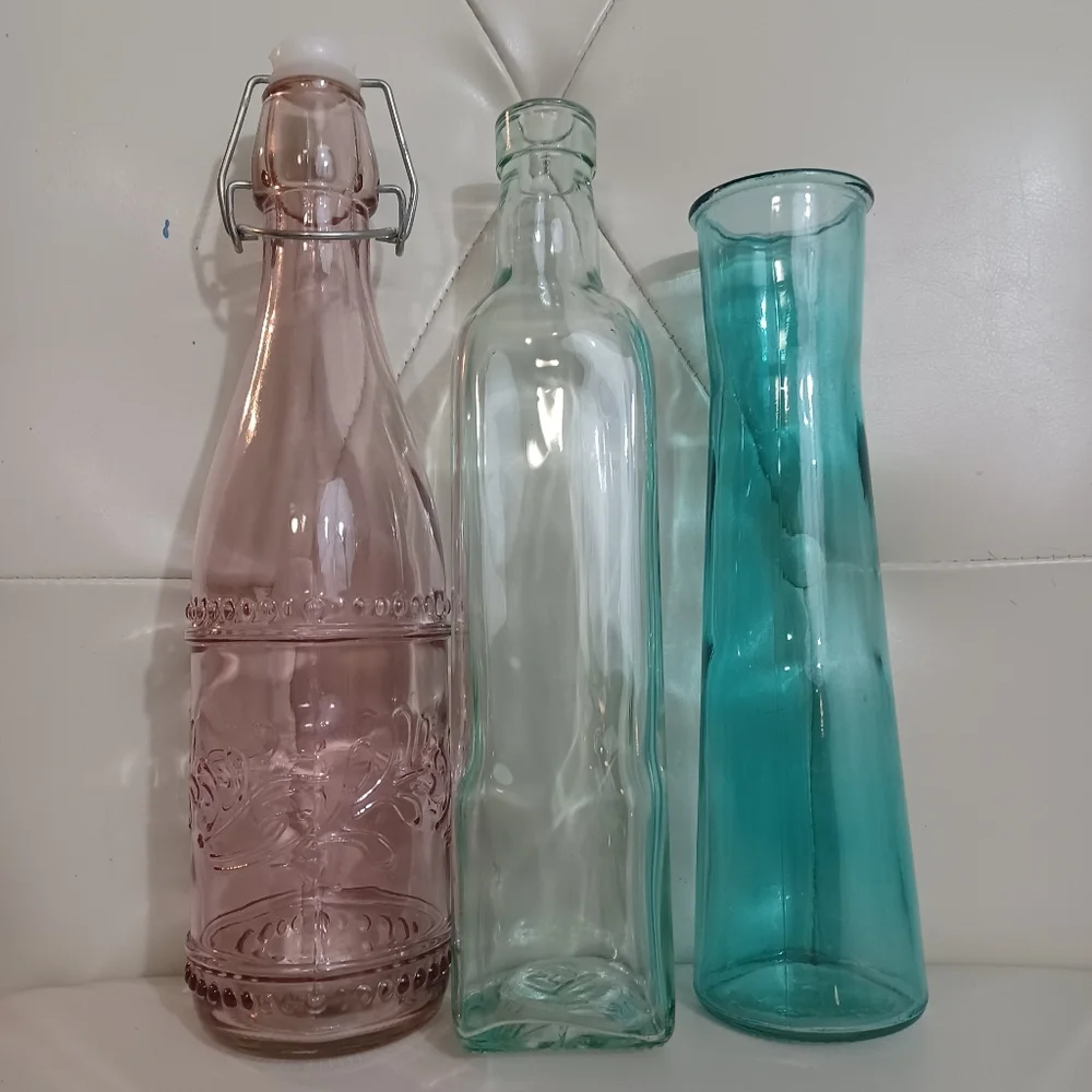 Set of Three Decorative Glass Bottles Clear Glass Light Pink And Teal Vases